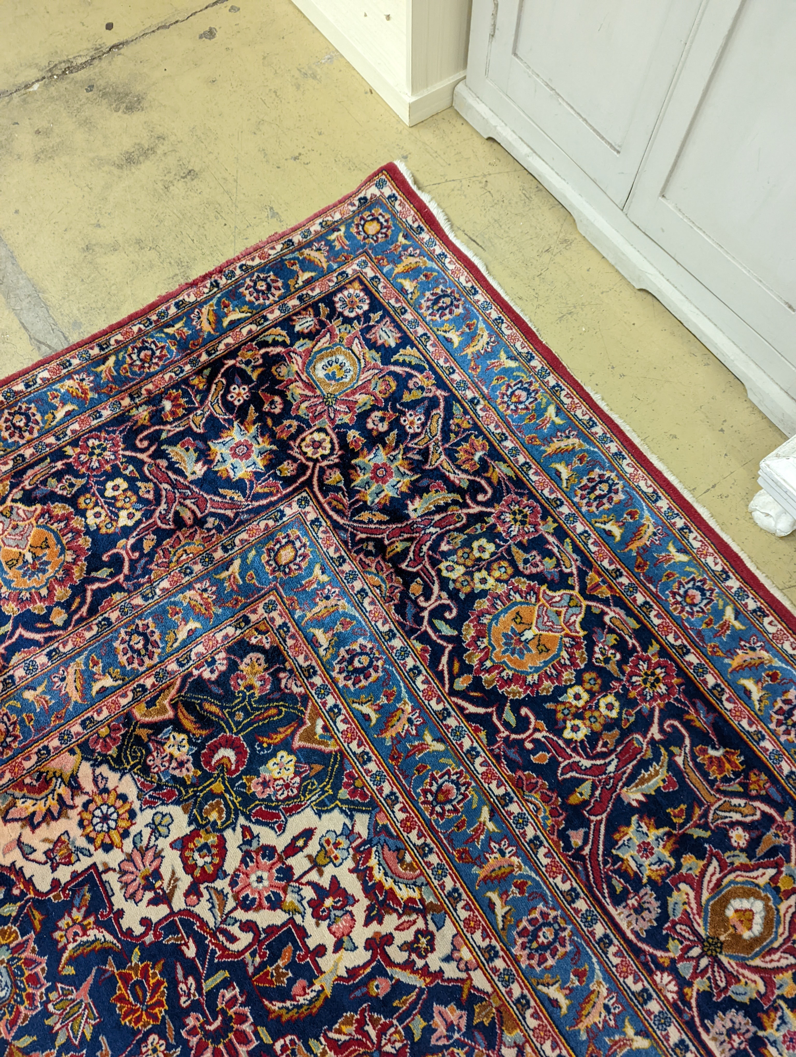 A large Tabriz red ground floral carpet, 540 x 350cm